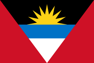 The flag of Antigua and Barbuda has a red field with an inverted isosceles triangle based on the top edge and spanning the height of the field. This triangle has three horizontal bands of black, light blue and white, with the light blue band half the height of the two other bands. The top half of a golden-yellow sun is situated in the lower two-third of the black band to depict a rising sun.
