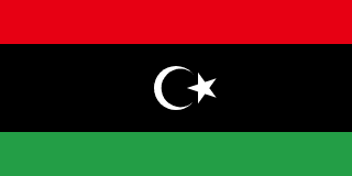 The flag of Libya is composed of three horizontal bands of red, black and green, with the black band twice the height of the other two bands. At the center of the black band is a fly-side facing white crescent and a five-pointed white star placed just outside the crescent opening.