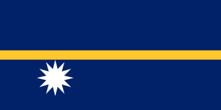 The flag of Nauru has a dark blue field with a thin yellow horizontal band across the center and a large white twelve-pointed star beneath the horizontal band on the hoist side of the field.