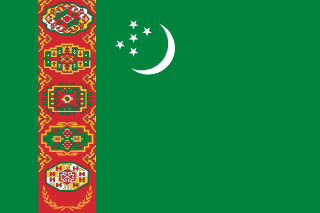 The flag of Turkmenistan has a green field. It features a red vertical band, bearing five carpet guls stacked above two crossed olive branches, near the hoist end of the field. Just to the fly side of the vertical band near the top edge of the field is a hoist-side facing white crescent and five small five-pointed white stars placed just outside the crescent opening.