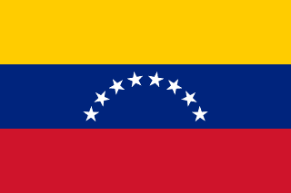 The flag of Venezuela is composed of three equal horizontal bands of yellow, blue and red. At the center of the blue band are eight five-pointed white stars arranged in a horizontal arc.