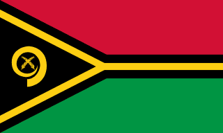 The flag of Vanuatu is composed of two equal horizontal bands of red and green, with a black isosceles triangle superimposed on the hoist side of the field. This triangle has its base on the hoist end, spans about two-fifth the width of the field and is enclosed on its sides by the arms of a thin black-edged yellow horizontally oriented Y-shaped band which extends along the boundary of the red and green bands to the fly end of the field. A yellow boar's tusk encircling two yellow crossed namele leaves is centered in the triangle.